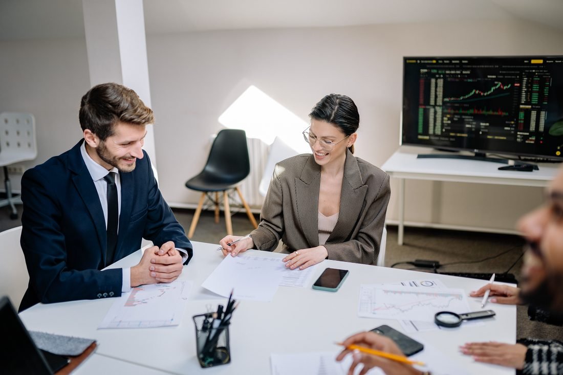 Advisor and client reviewing financial charts and paperwork together in a meeting